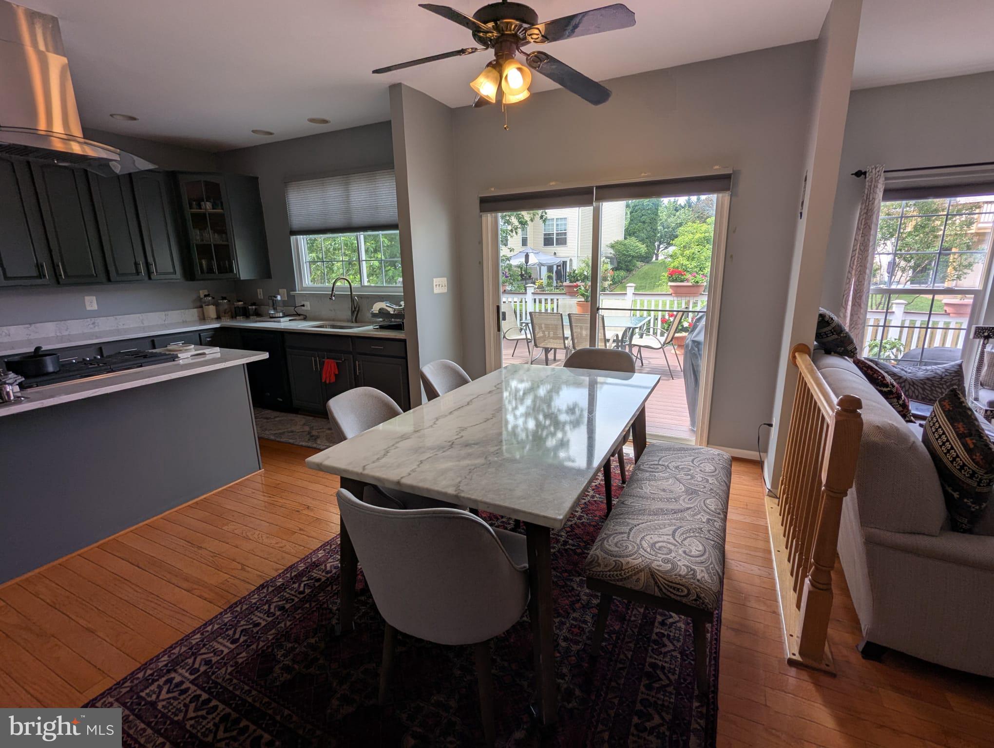 9871 Upper Mill Loop Bristow, VA 20136 - Photo 16 of 84 a view of a dining room with furniture window and wooden floor