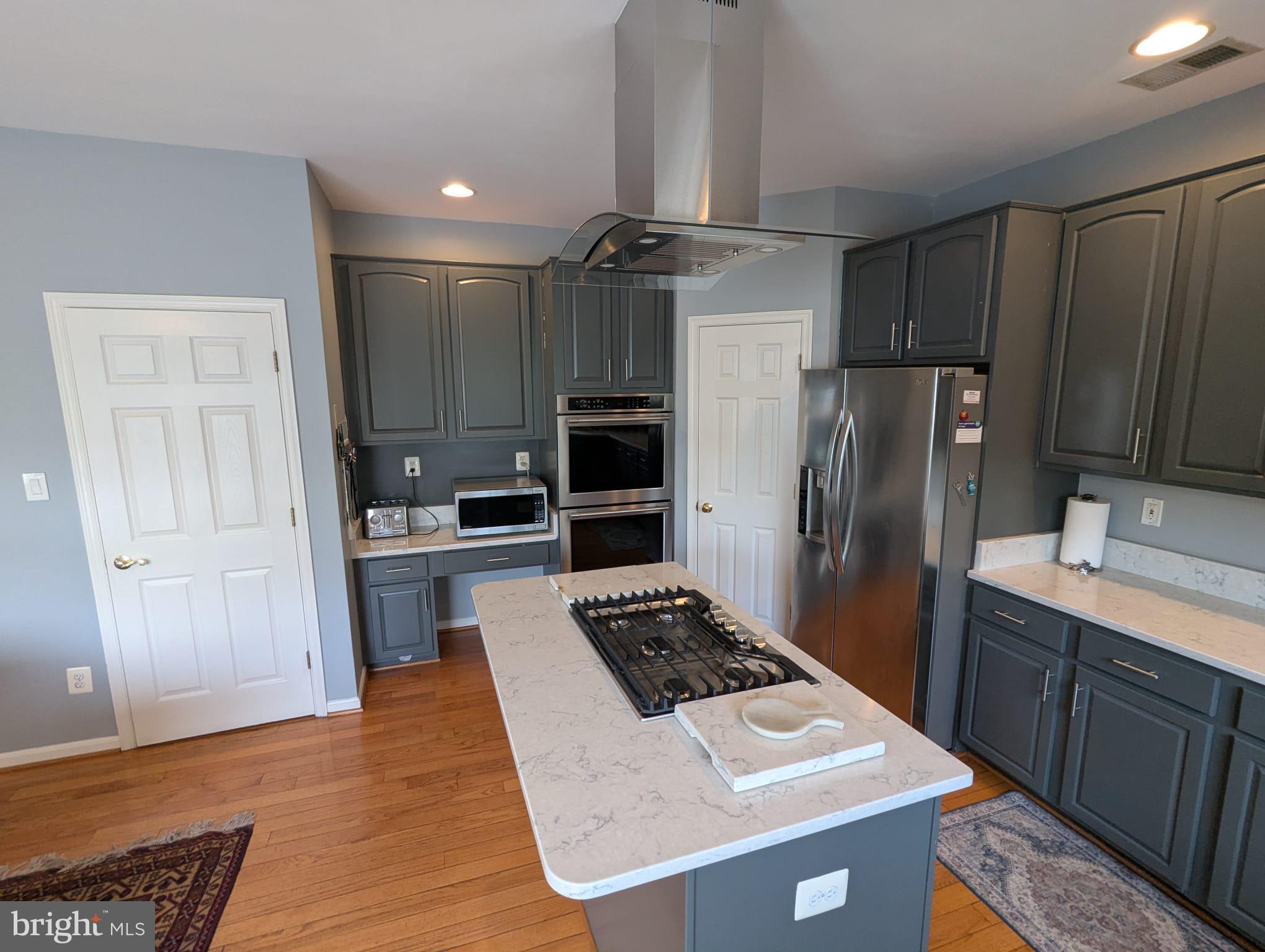 9871 Upper Mill Loop Bristow, VA 20136 - Photo 17 of 84 a kitchen with a refrigerator sink and stove