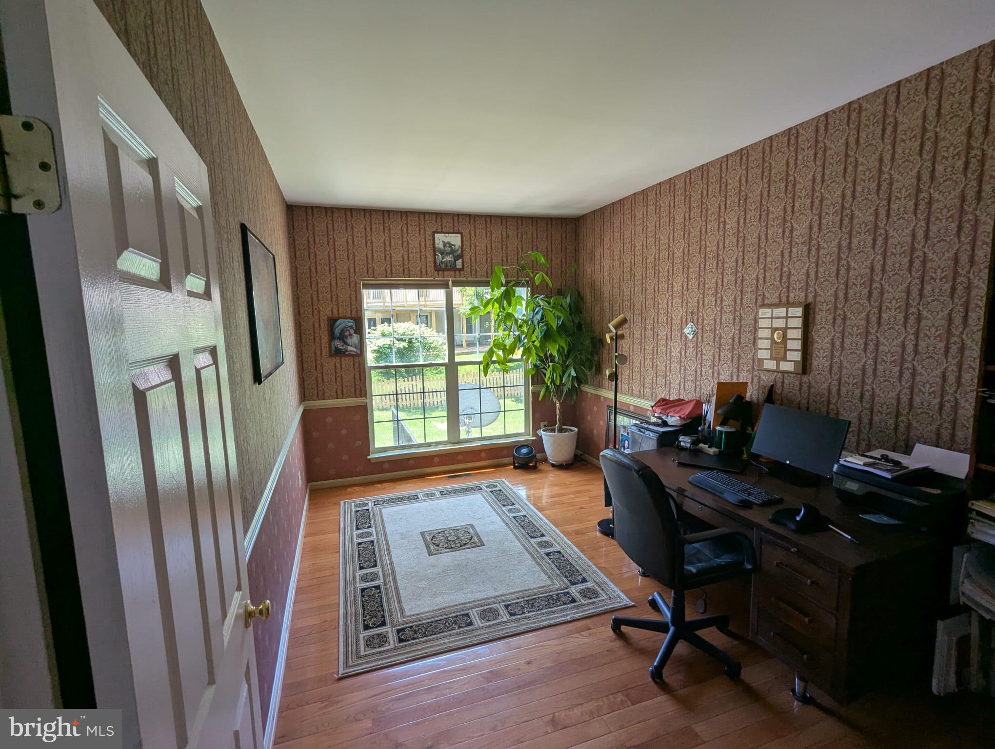 9871 Upper Mill Loop Bristow, VA 20136 - Photo 19 of 84 a view of a workspace with furniture and a window