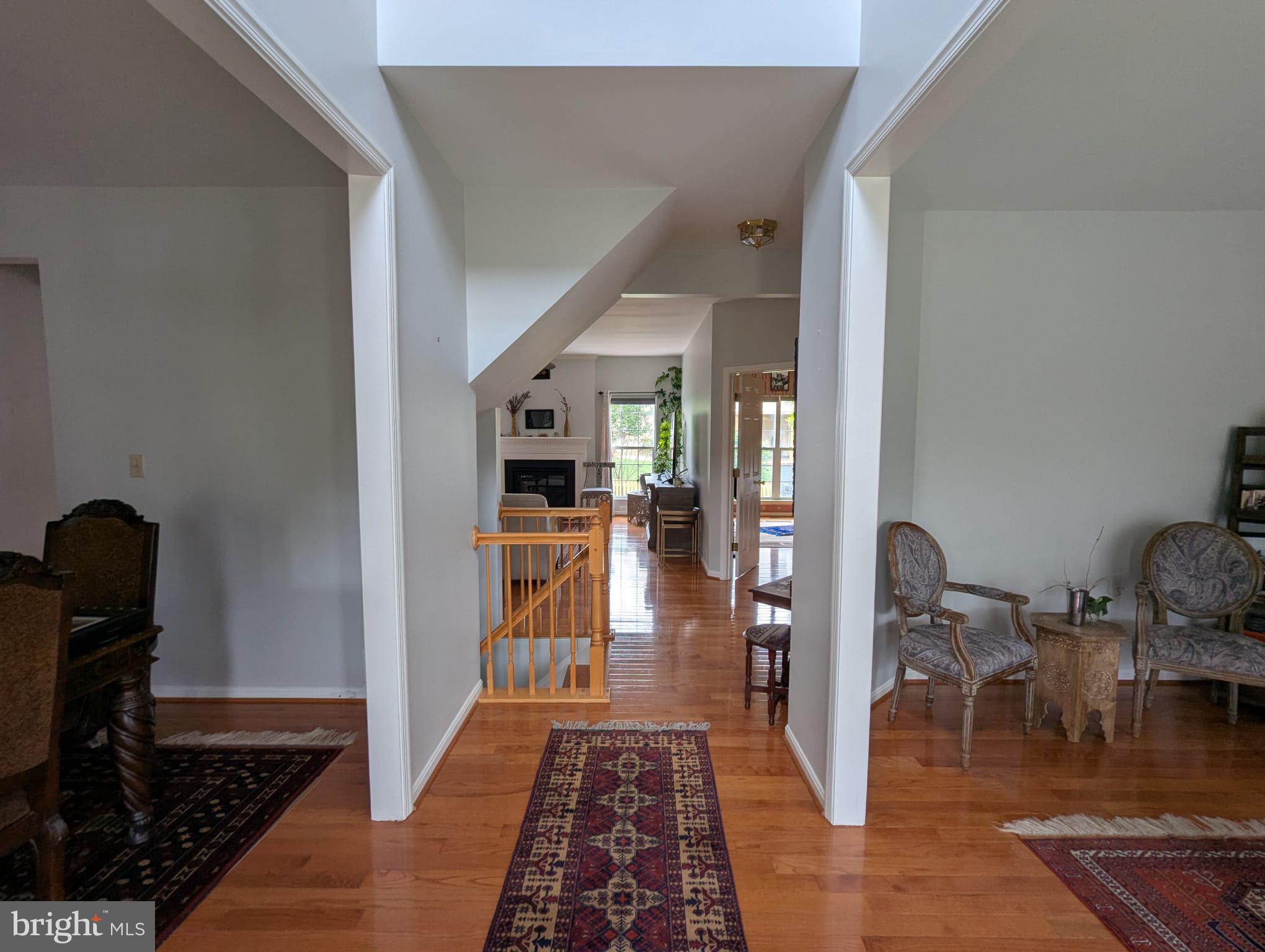 9871 Upper Mill Loop Bristow, VA 20136 - Photo 2 of 84 a hallway with dining area and livingroom view