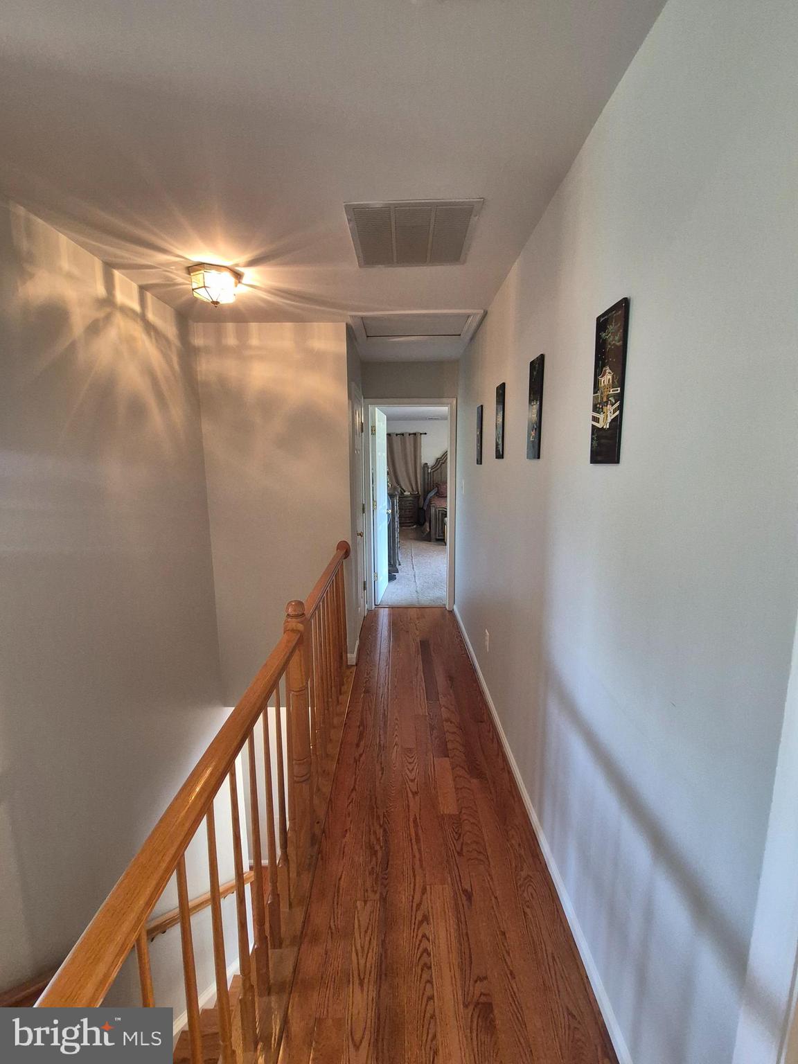 9871 Upper Mill Loop Bristow, VA 20136 - Photo 27 of 84 a view of a hallway with wooden floor