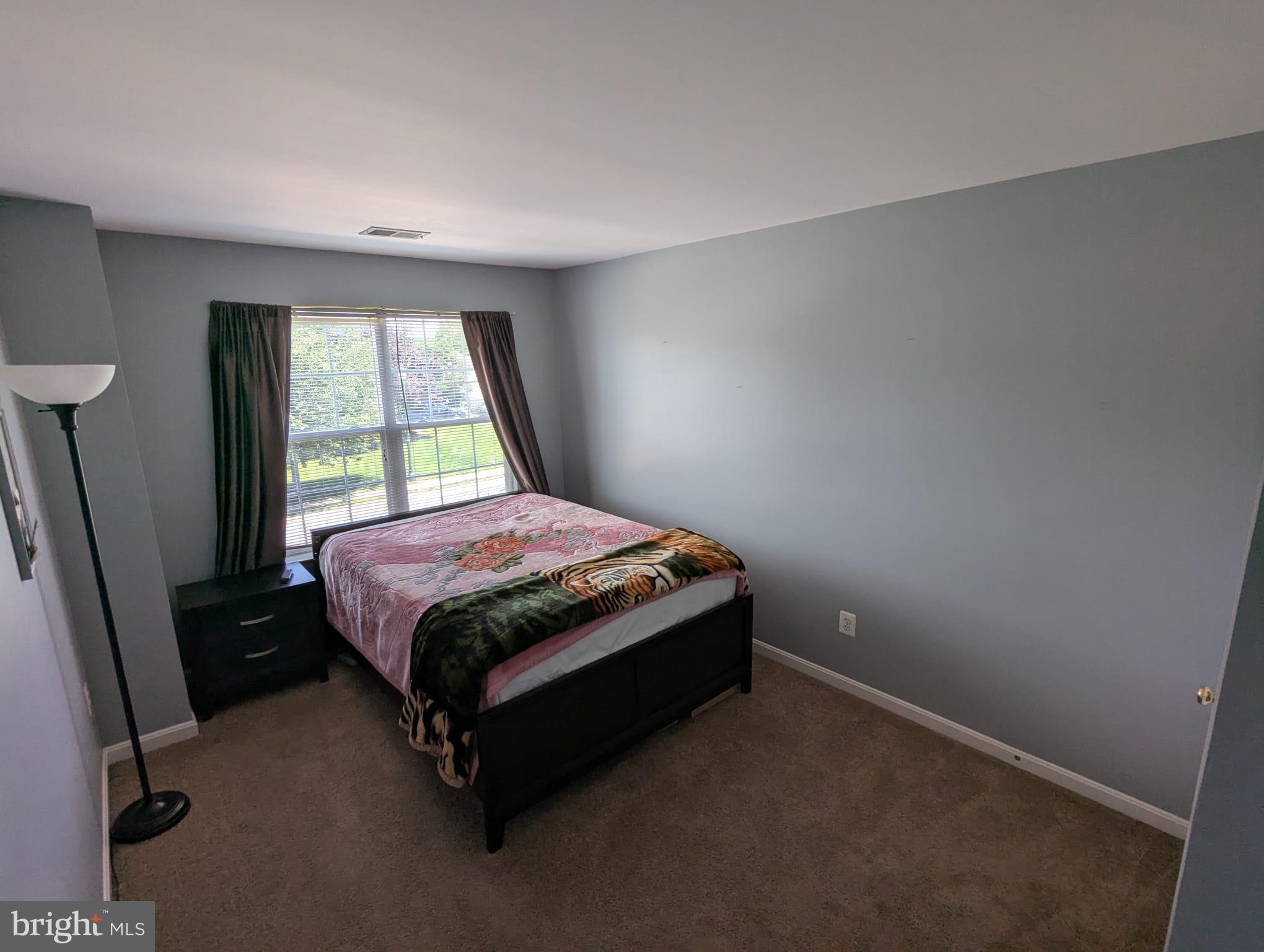 9871 Upper Mill Loop Bristow, VA 20136 - Photo 32 of 84 a bed sitting in a room next to a window