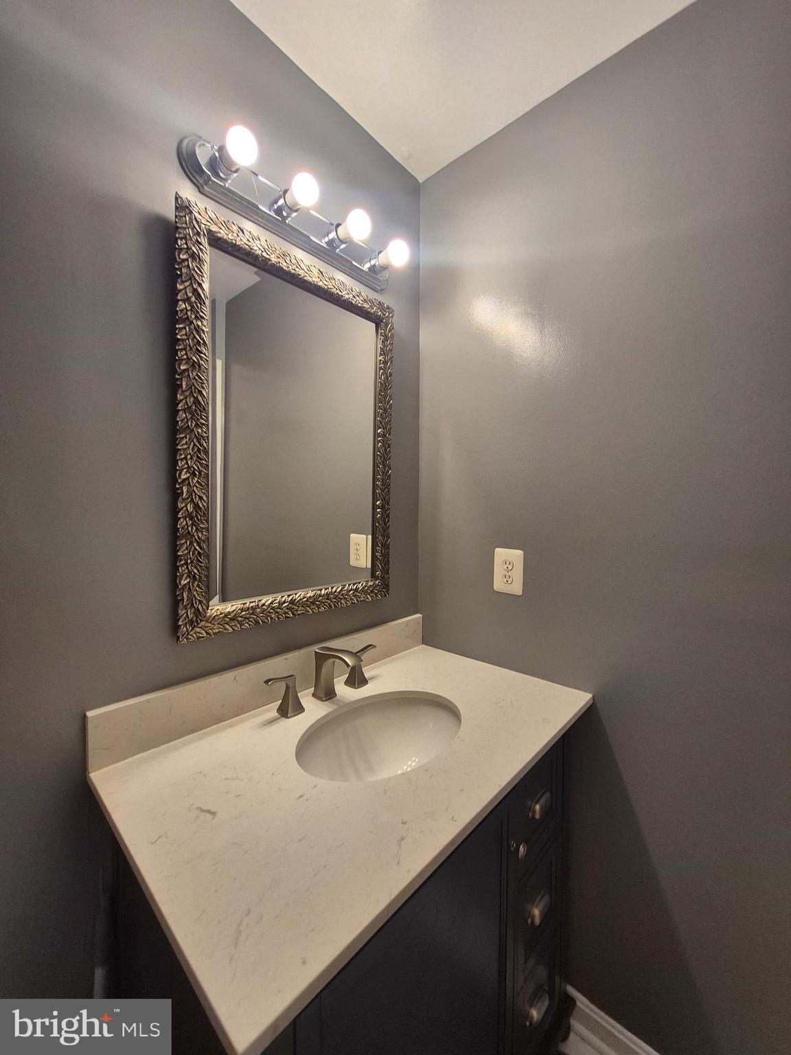 9871 Upper Mill Loop Bristow, VA 20136 - Photo 38 of 84 a bathroom with a sink vanity and a mirror