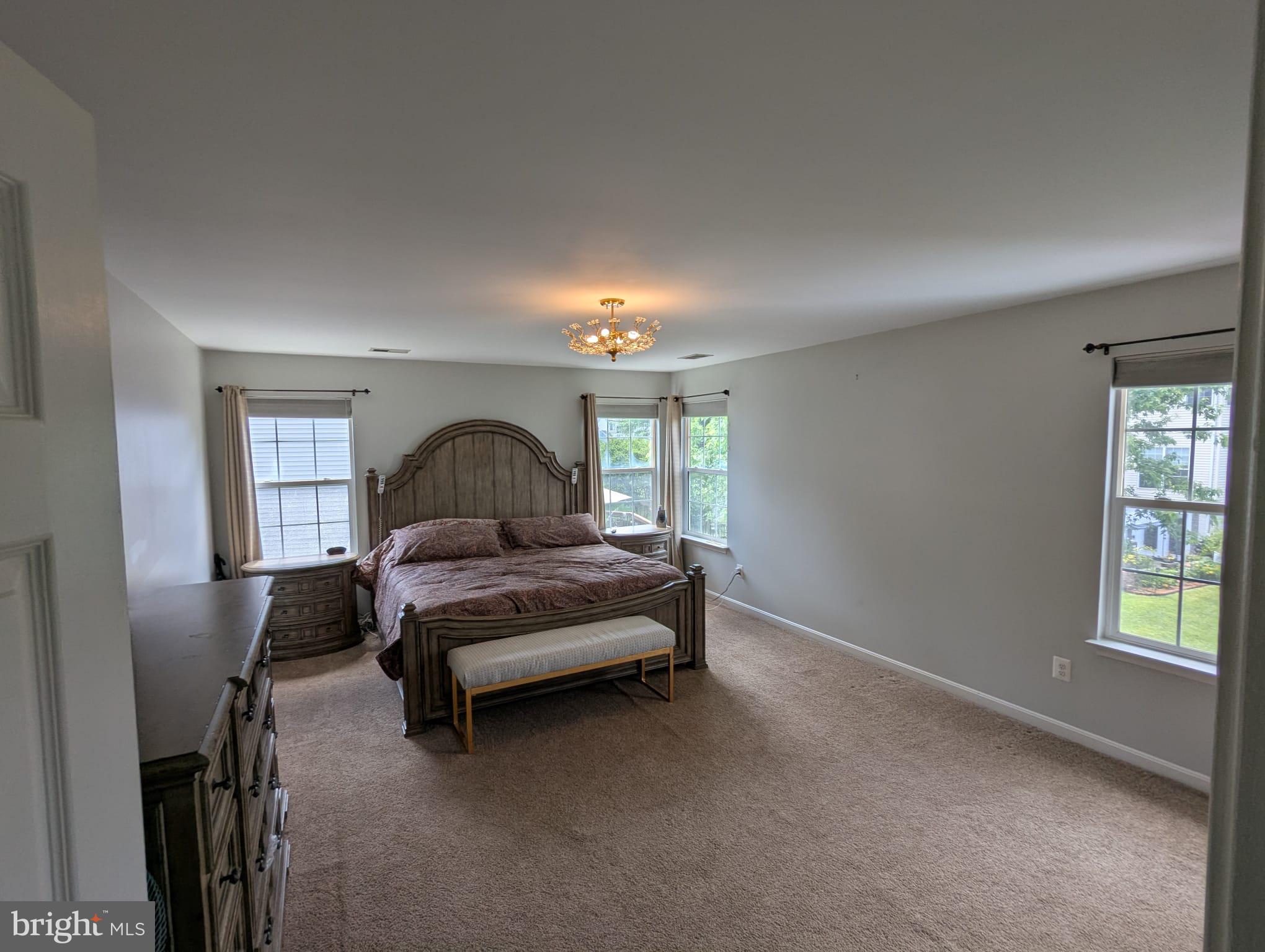 9871 Upper Mill Loop Bristow, VA 20136 - Photo 42 of 84 a living room with furniture and a window