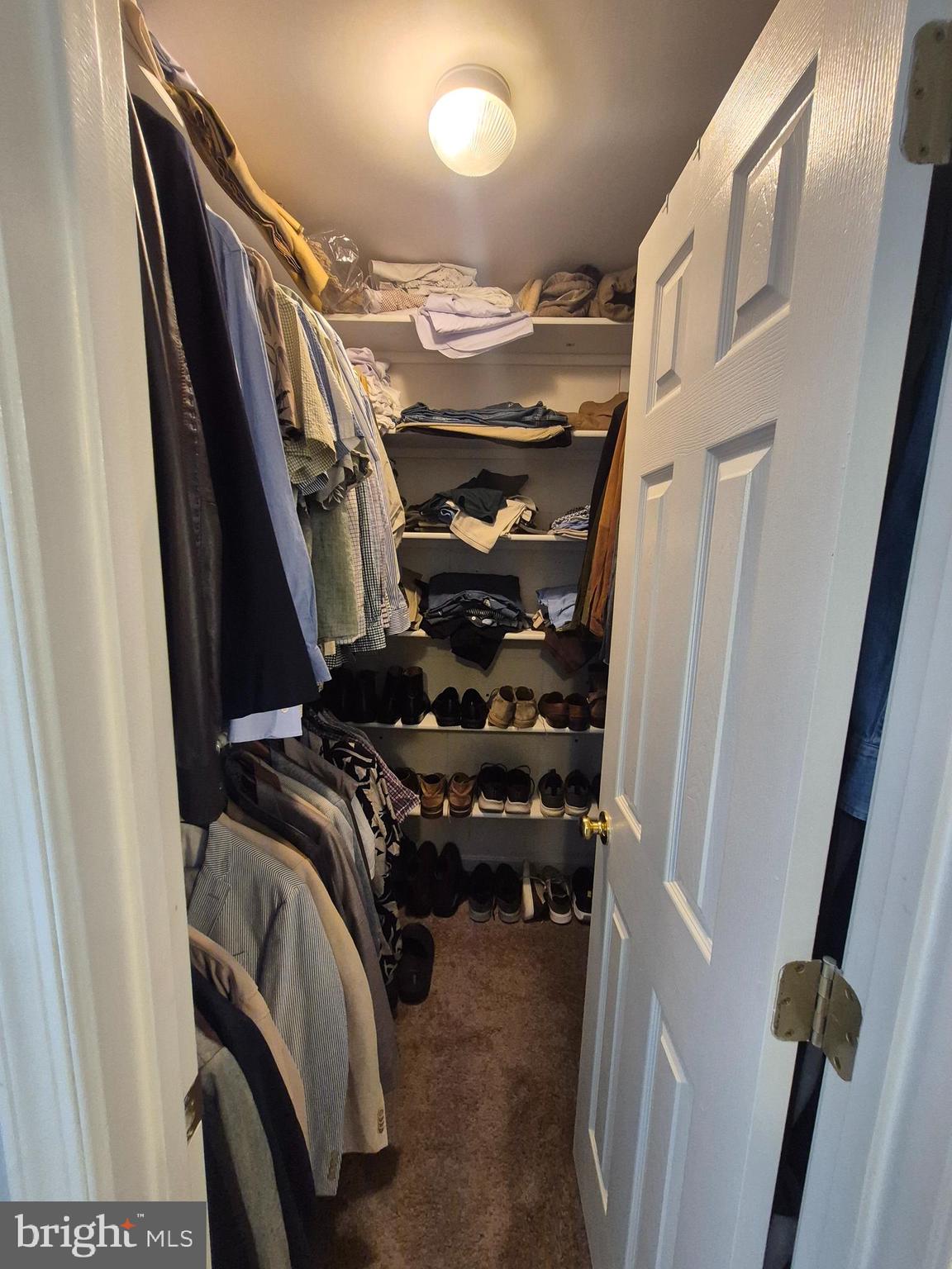 9871 Upper Mill Loop Bristow, VA 20136 - Photo 47 of 84 a view of walk in closet with clothes and shoes