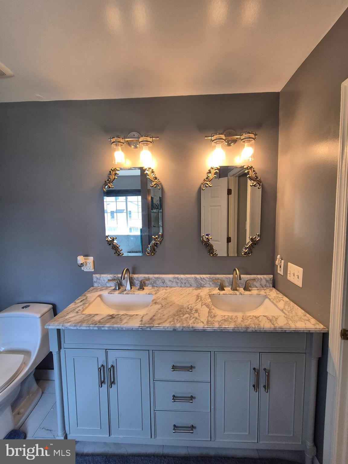9871 Upper Mill Loop Bristow, VA 20136 - Photo 51 of 84 a bathroom with a sink and a mirror
