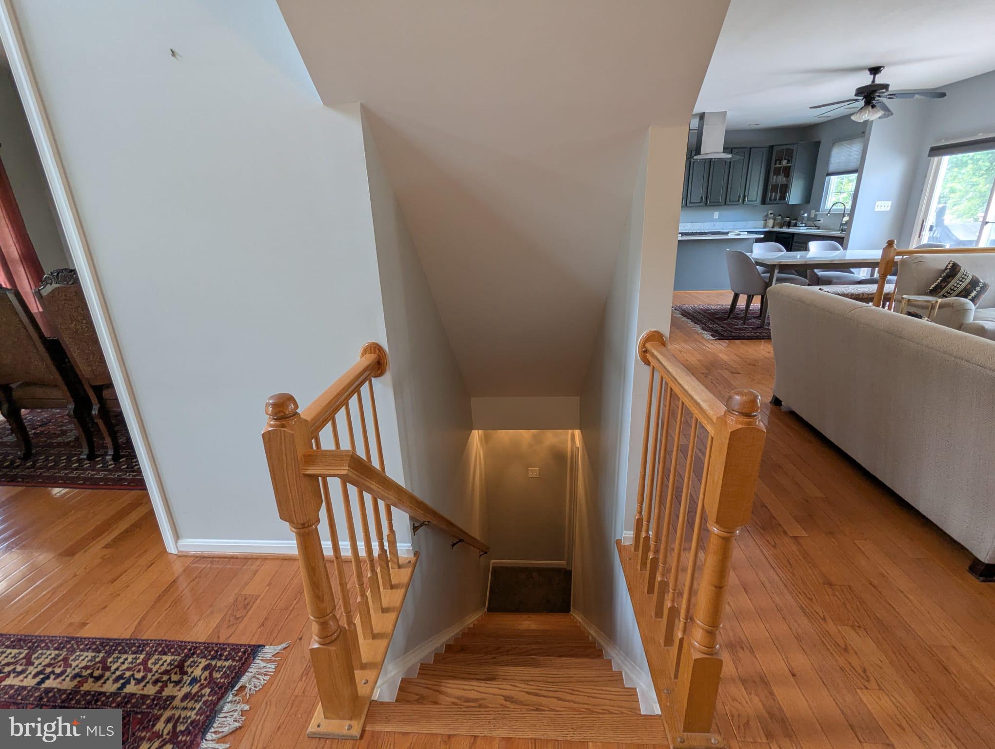 9871 Upper Mill Loop Bristow, VA 20136 - Photo 58 of 84 a view of a livingroom with furniture wooden floor and staircase