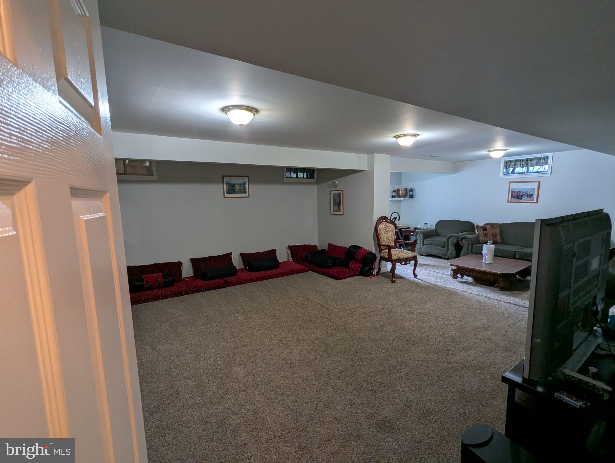 9871 Upper Mill Loop Bristow, VA 20136 - Photo 59 of 84 a living room with furniture and a flat screen tv