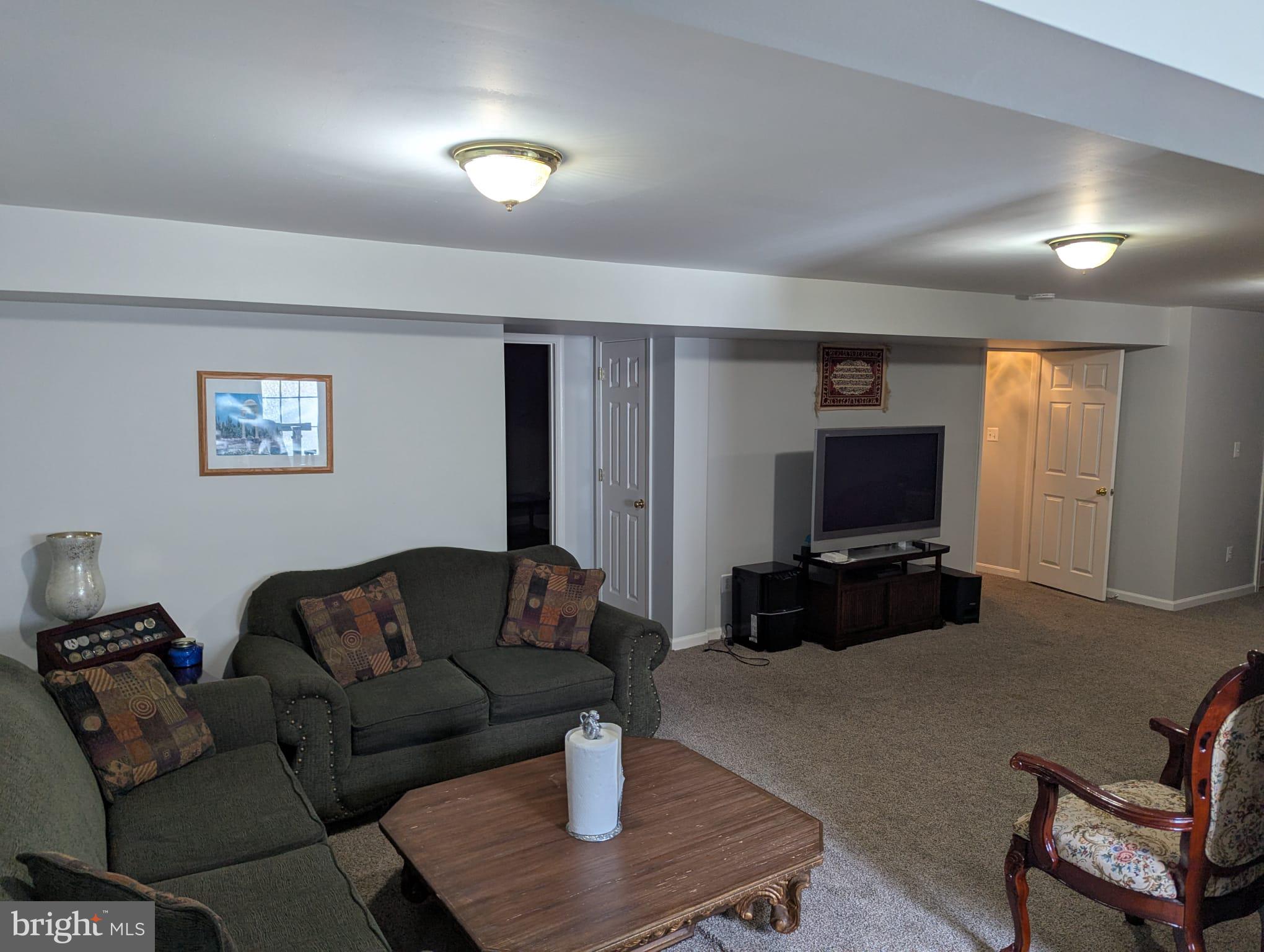 9871 Upper Mill Loop Bristow, VA 20136 - Photo 61 of 84 a living room with furniture and a flat screen tv