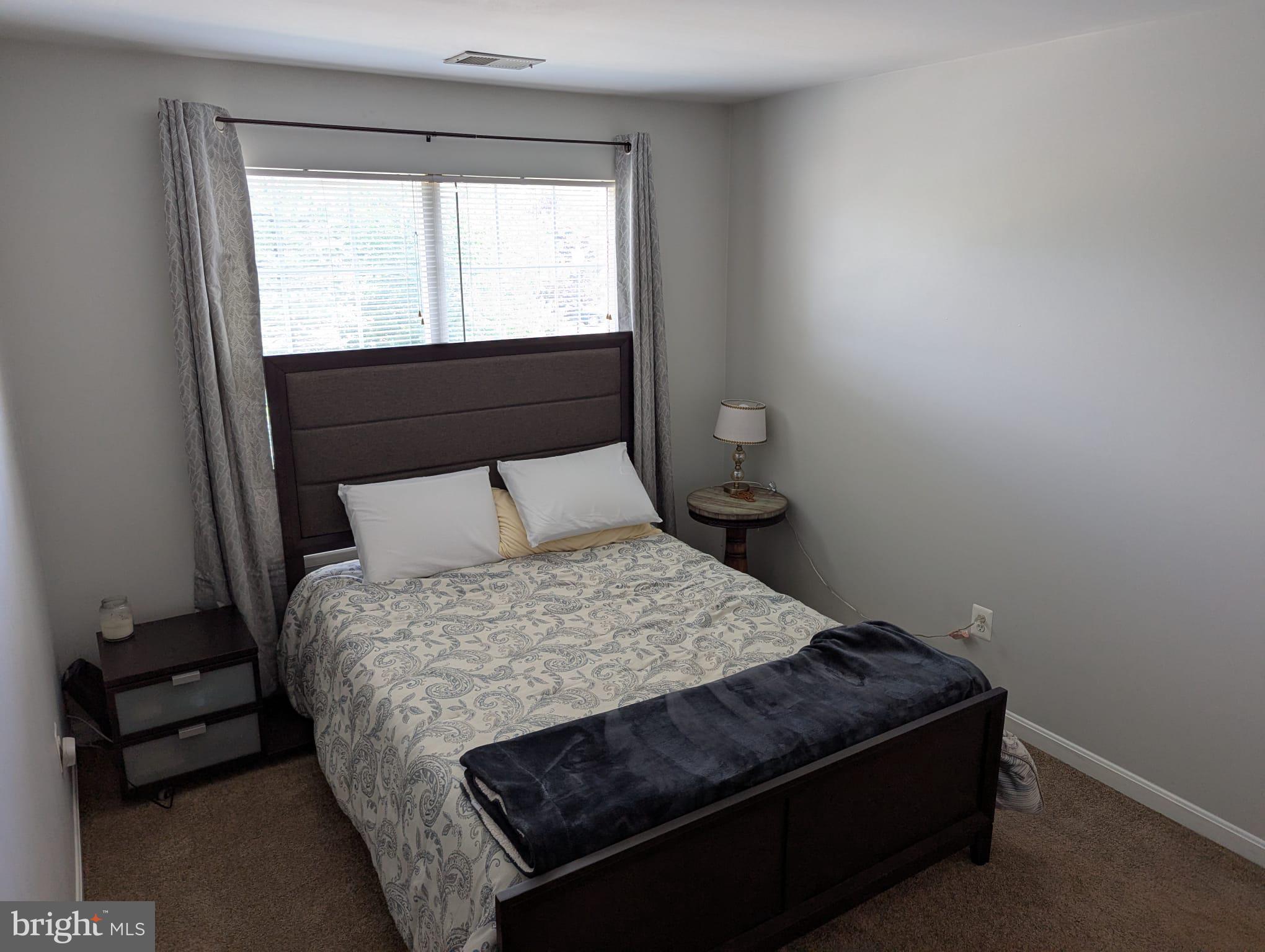 9871 Upper Mill Loop Bristow, VA 20136 - Photo 63 of 84 a bedroom with a bed and a window