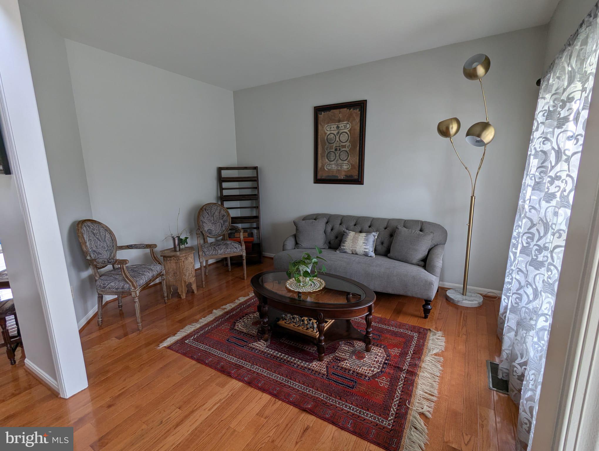 9871 Upper Mill Loop Bristow, VA 20136 - Photo 8 of 84 a living room with furniture and a wooden floor