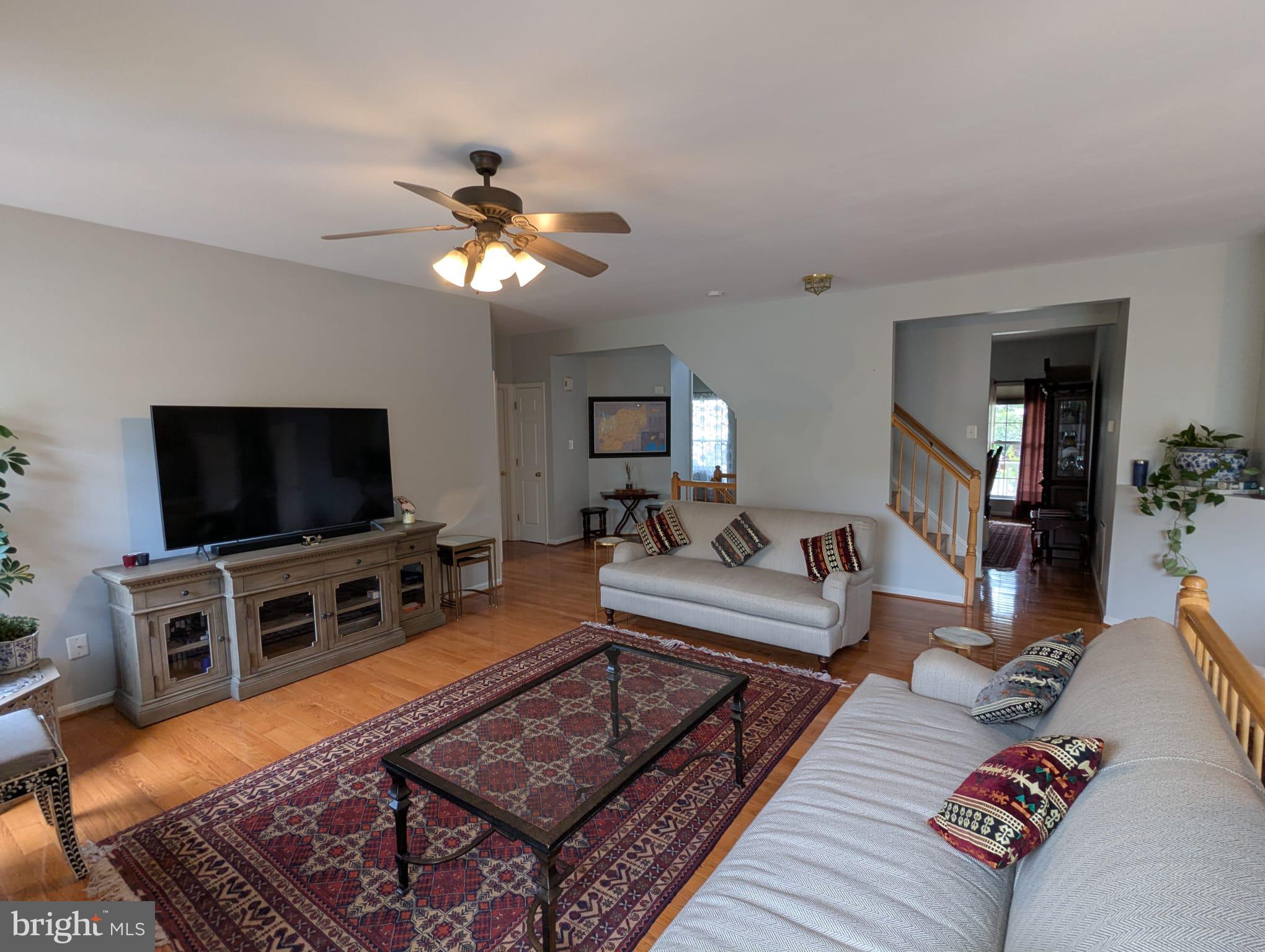 9871 Upper Mill Loop Bristow, VA 20136 - Photo 10 of 84 a living room with furniture and a flat screen tv