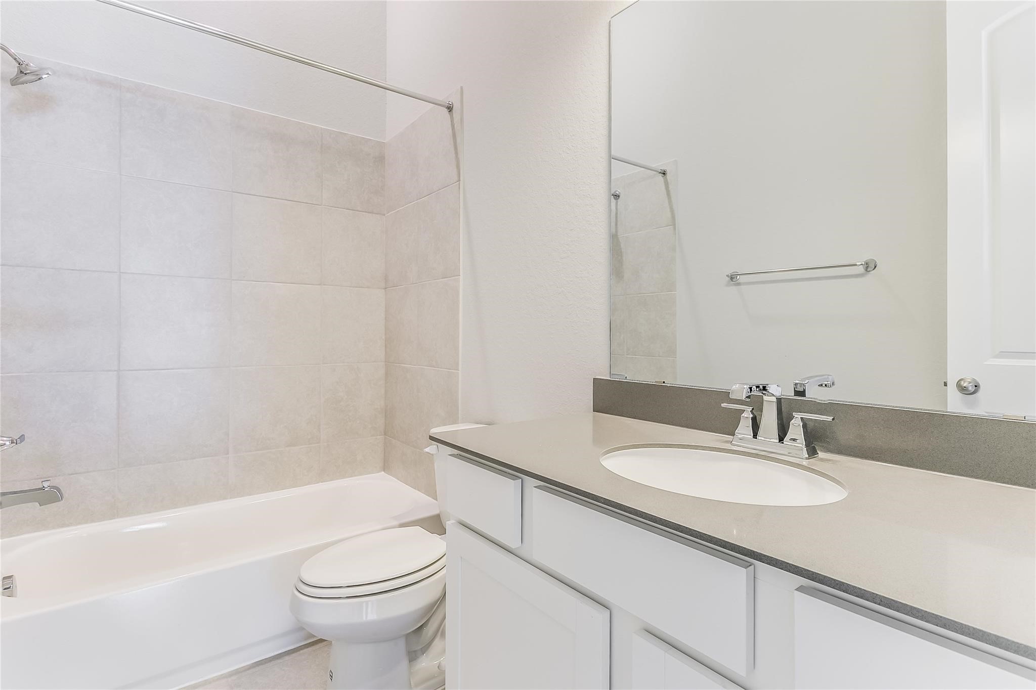 4227 Carol Ridge Drive Sugar Land, TX 77479 - Photo 23 of 35 a bathroom with a sink a toilet and a bathtub