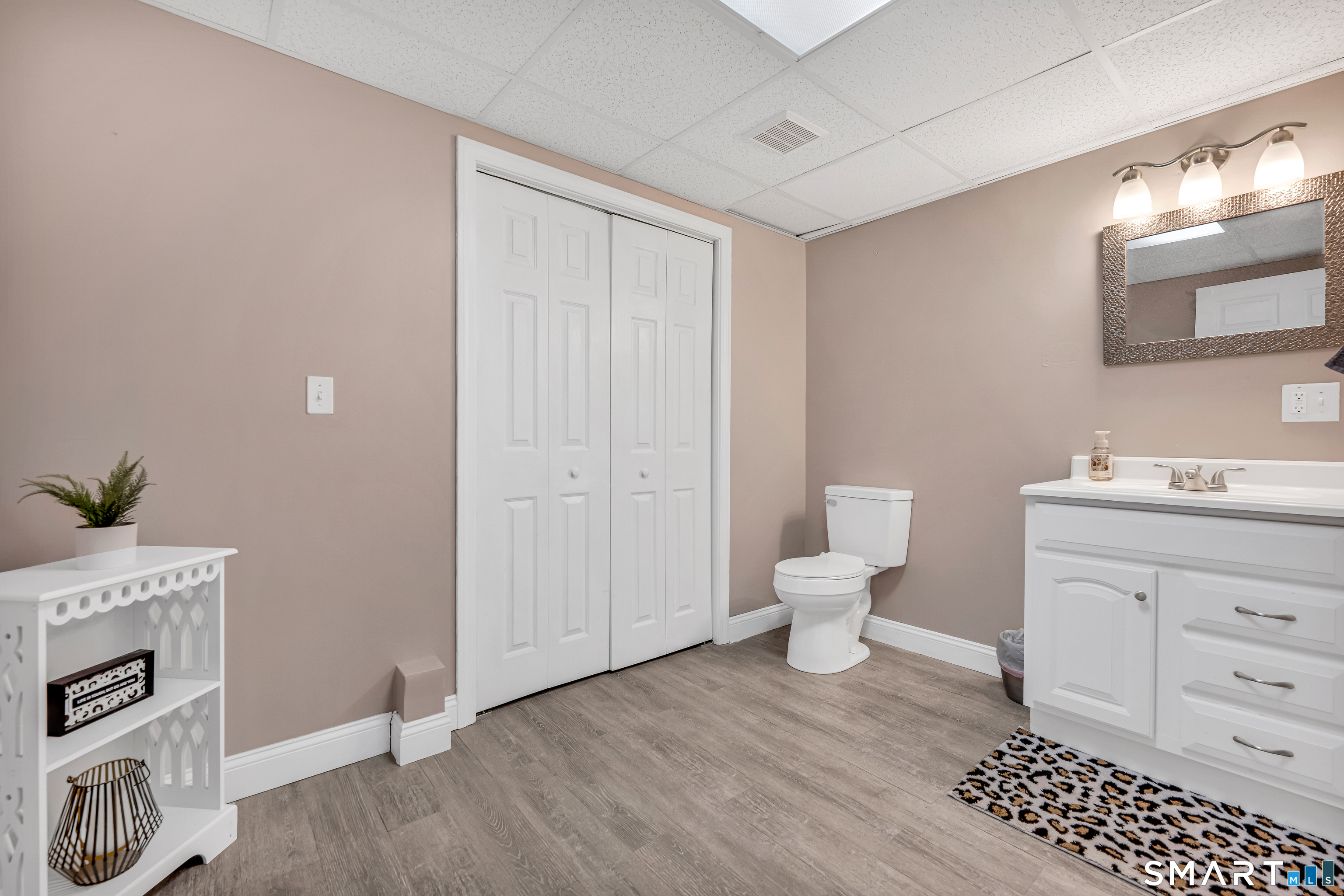 409 Beckley Road Berlin, CT 06037 - Photo 26 of 39 a bathroom with a toilet a sink and a mirror