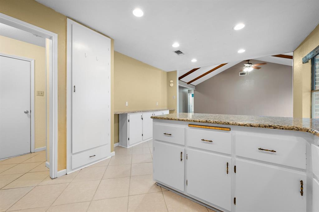 1102 Lena Street Cleburne, TX 76033 - Photo 15 of 36 a spacious bathroom with a granite countertop sink and a mirror