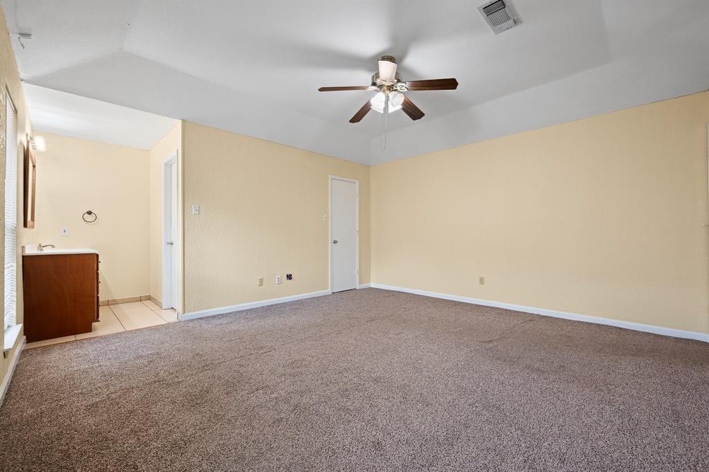 1102 Lena Street Cleburne, TX 76033 - Photo 18 of 36 a view of an empty room with a chandelier fan