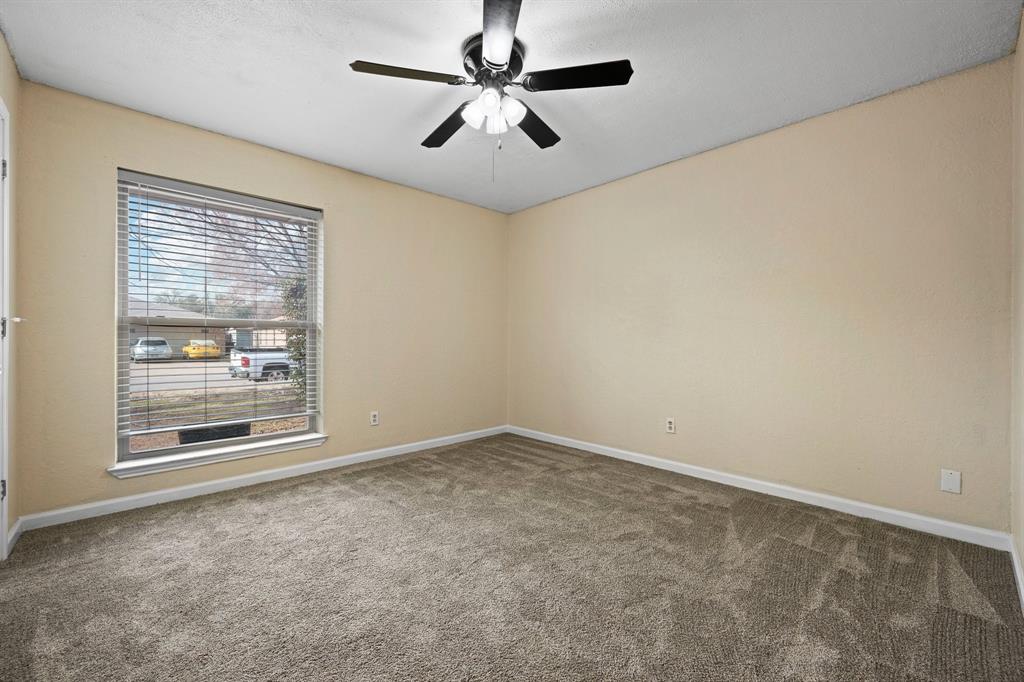 1102 Lena Street Cleburne, TX 76033 - Photo 23 of 36 an empty room with windows and fan