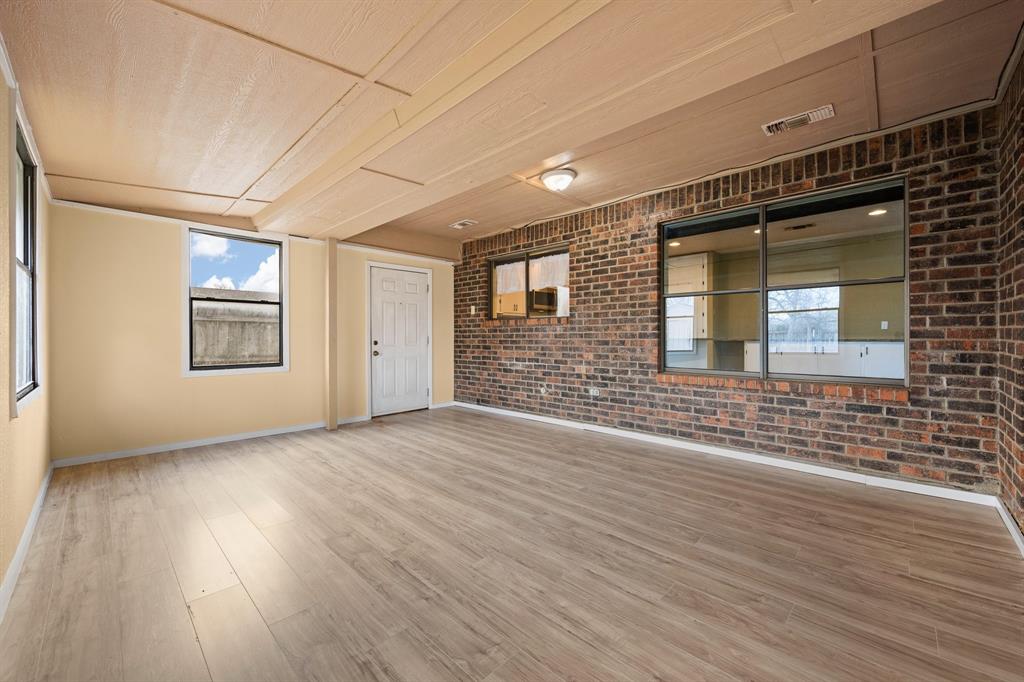 1102 Lena Street Cleburne, TX 76033 - Photo 29 of 36 an empty room with wooden floor and windows