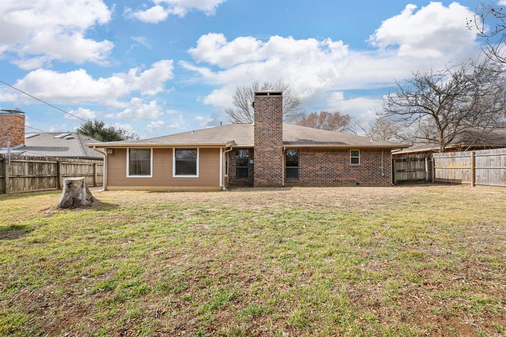 1102 Lena Street Cleburne, TX 76033 - Photo 31 of 36 a front view of a house with a garden