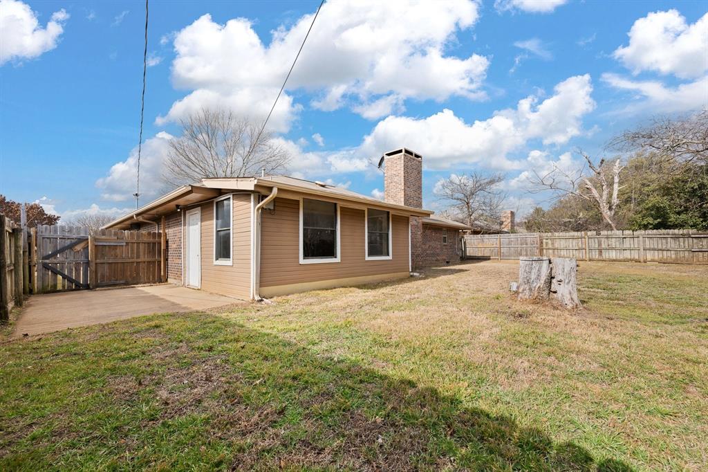 1102 Lena Street Cleburne, TX 76033 - Photo 33 of 36 a big white house with a big yard and large trees