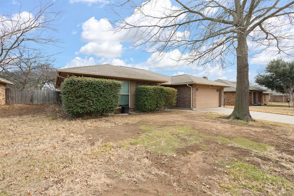 1102 Lena Street Cleburne, TX 76033 - Photo 36 of 36 a view of a house with a large tree and a yard