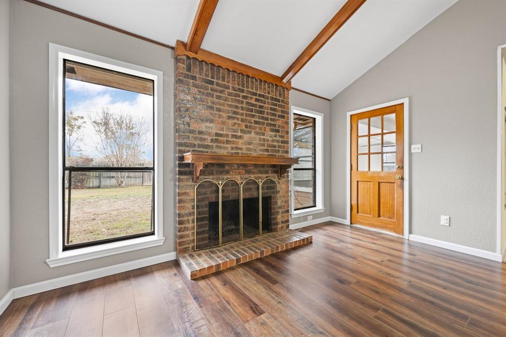 1102 Lena Street Cleburne, TX 76033 - Photo 6 of 36 a view of an empty room with wooden floor and a window
