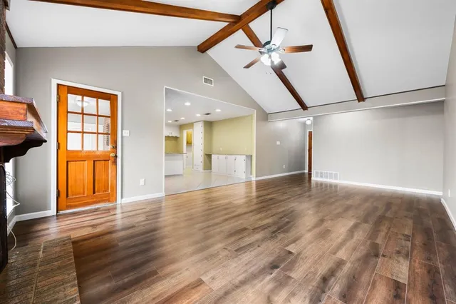 a view of an entryway with wooden floor