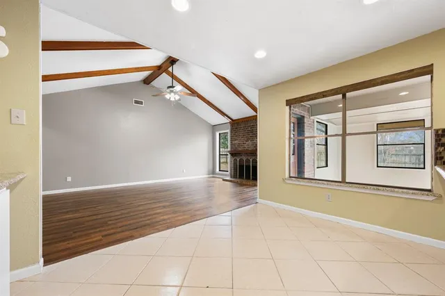 a view of an empty room with glass door