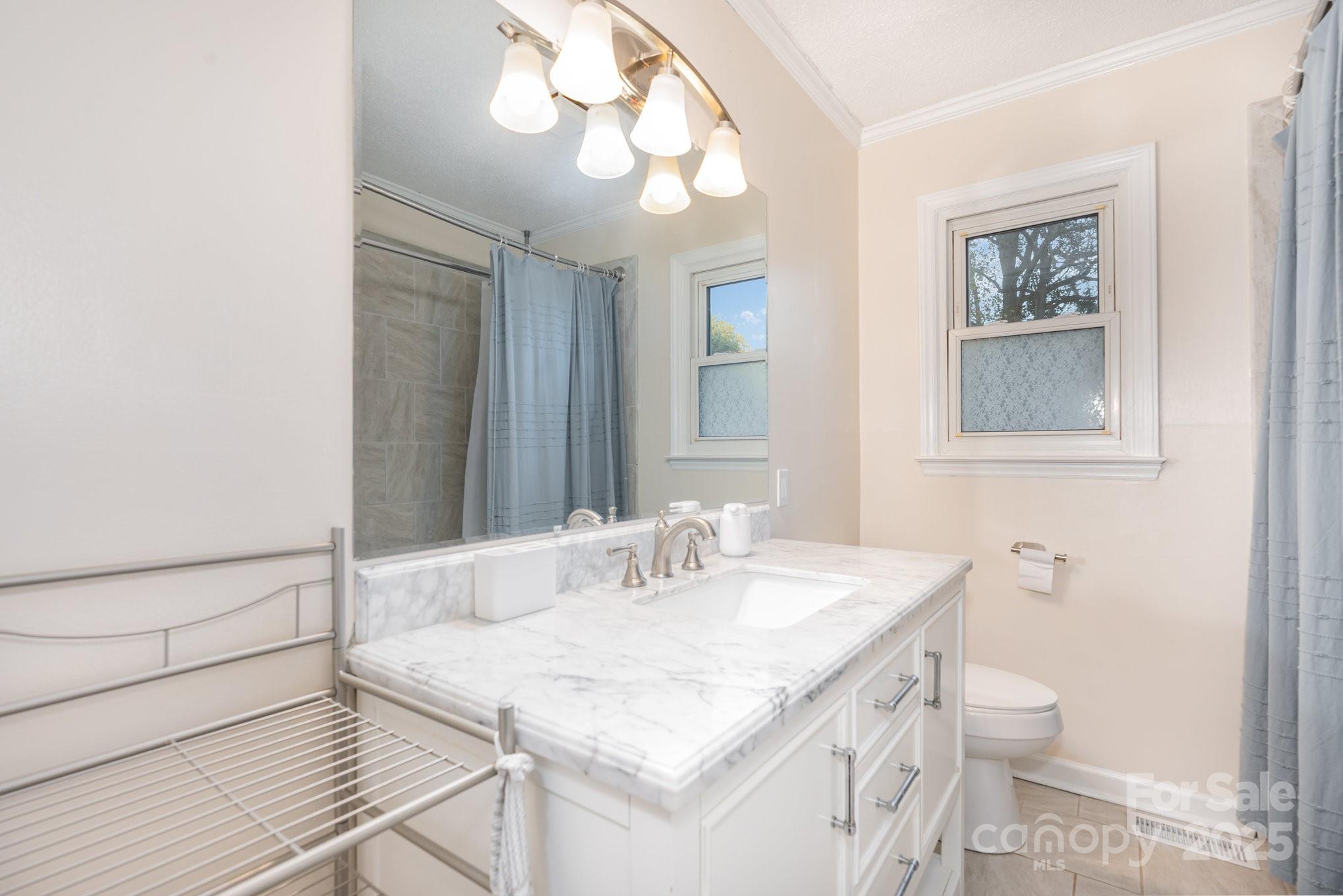 512 Ralphs Boulevard Gastonia, NC 28052 - Photo 24 of 32 a bathroom with a sink a toilet and a mirror