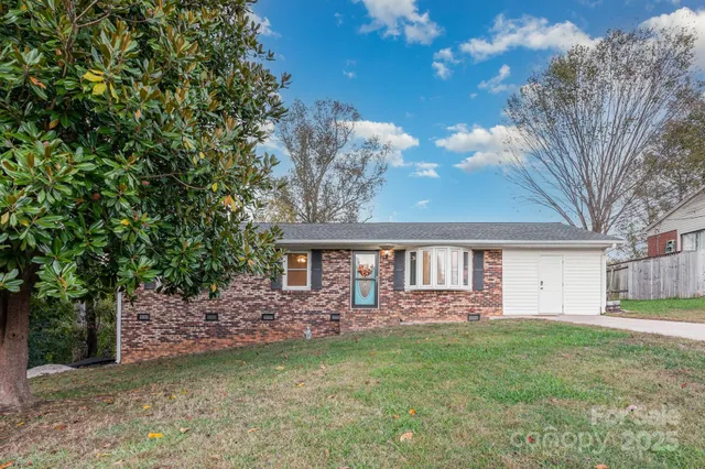 a front view of a house with a garden and outdoor seating