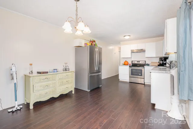 a kitchen with stainless steel appliances a refrigerator sink and cabinets