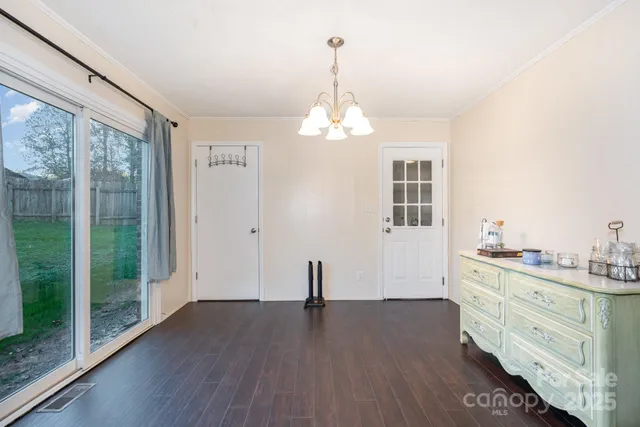 a view of a room with wooden floor and windows