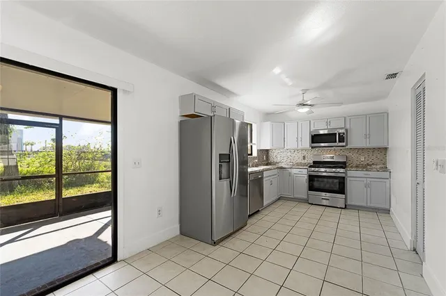 a kitchen with stainless steel appliances granite countertop a stove sink and cabinets