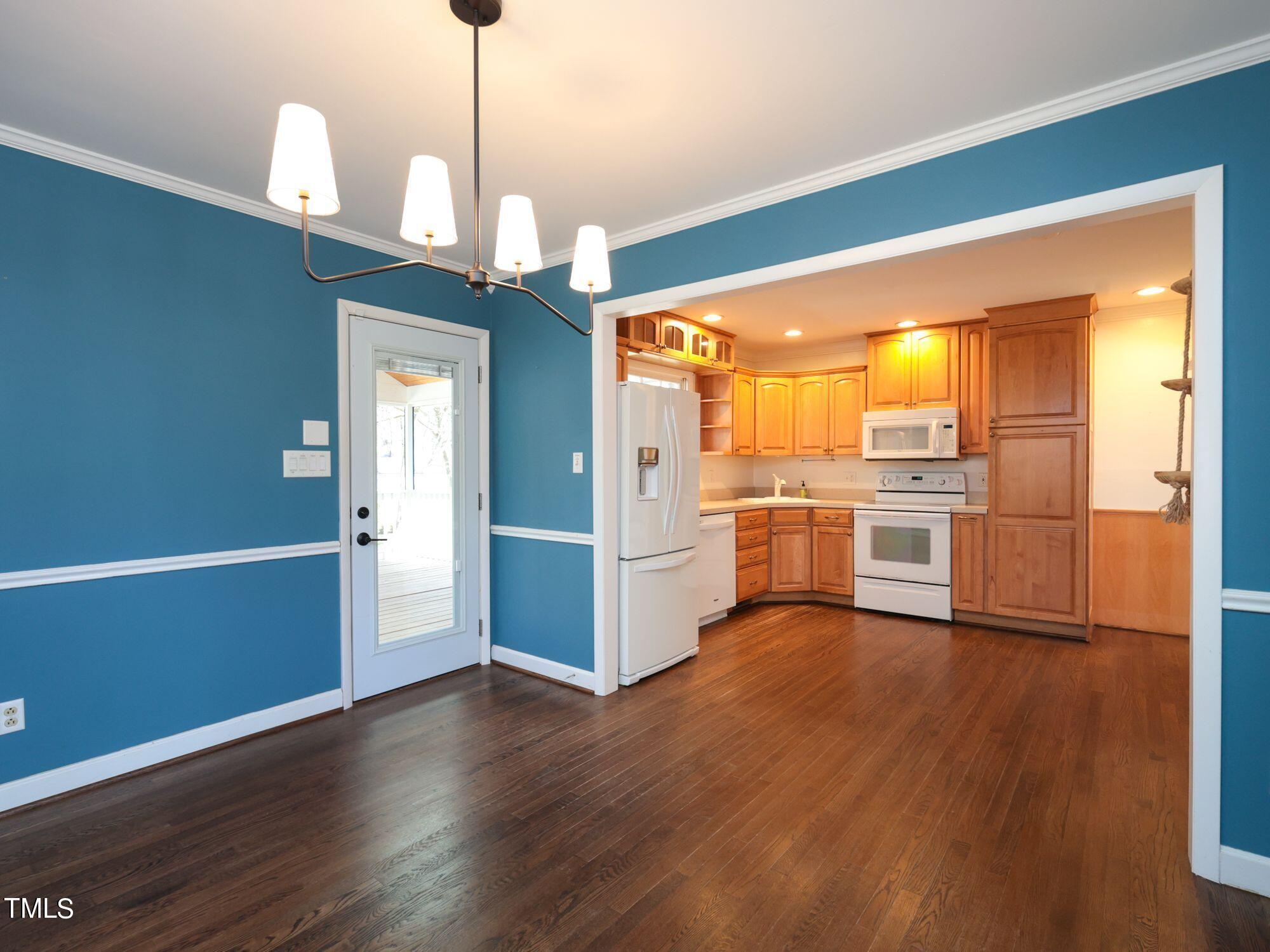529 Harvard Street Raleigh, NC 27609 - Photo 11 of 48 a view of a kitchen with wooden floor electronic appliances and cabinets