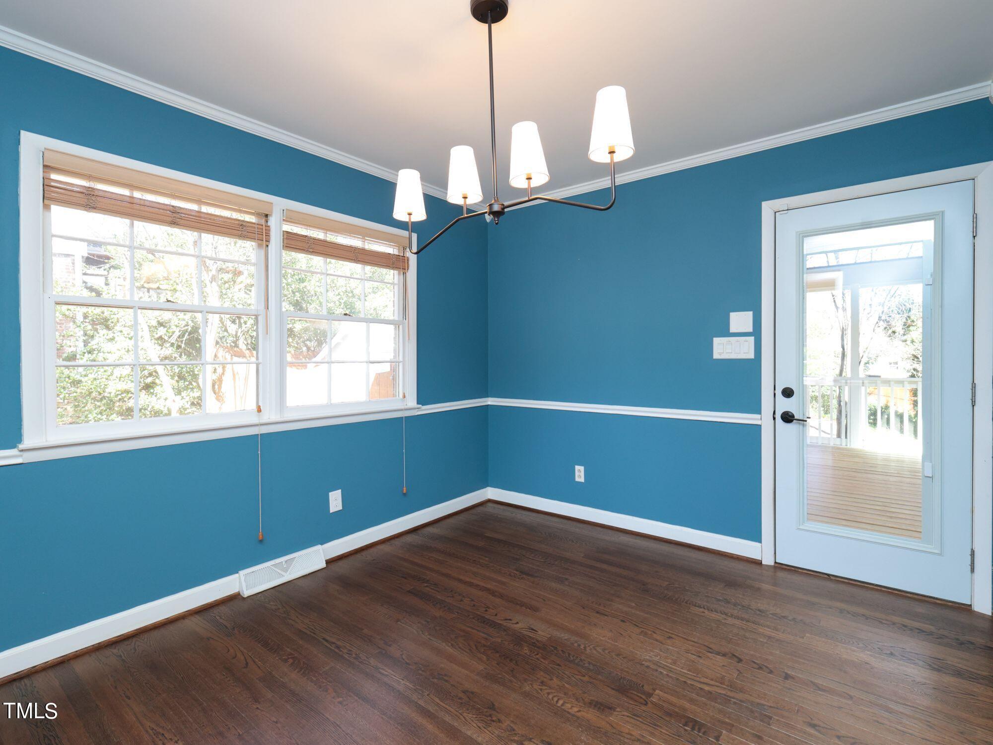 529 Harvard Street Raleigh, NC 27609 - Photo 12 of 48 a room with window and wooden floor