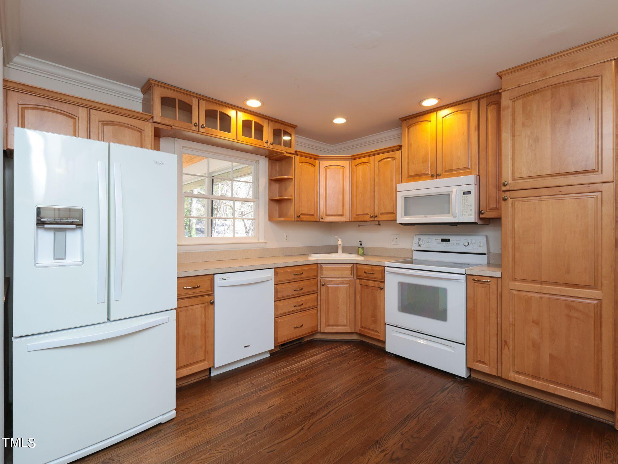 529 Harvard Street Raleigh, NC 27609 - Photo 13 of 48 a kitchen with granite countertop white cabinets and white appliances