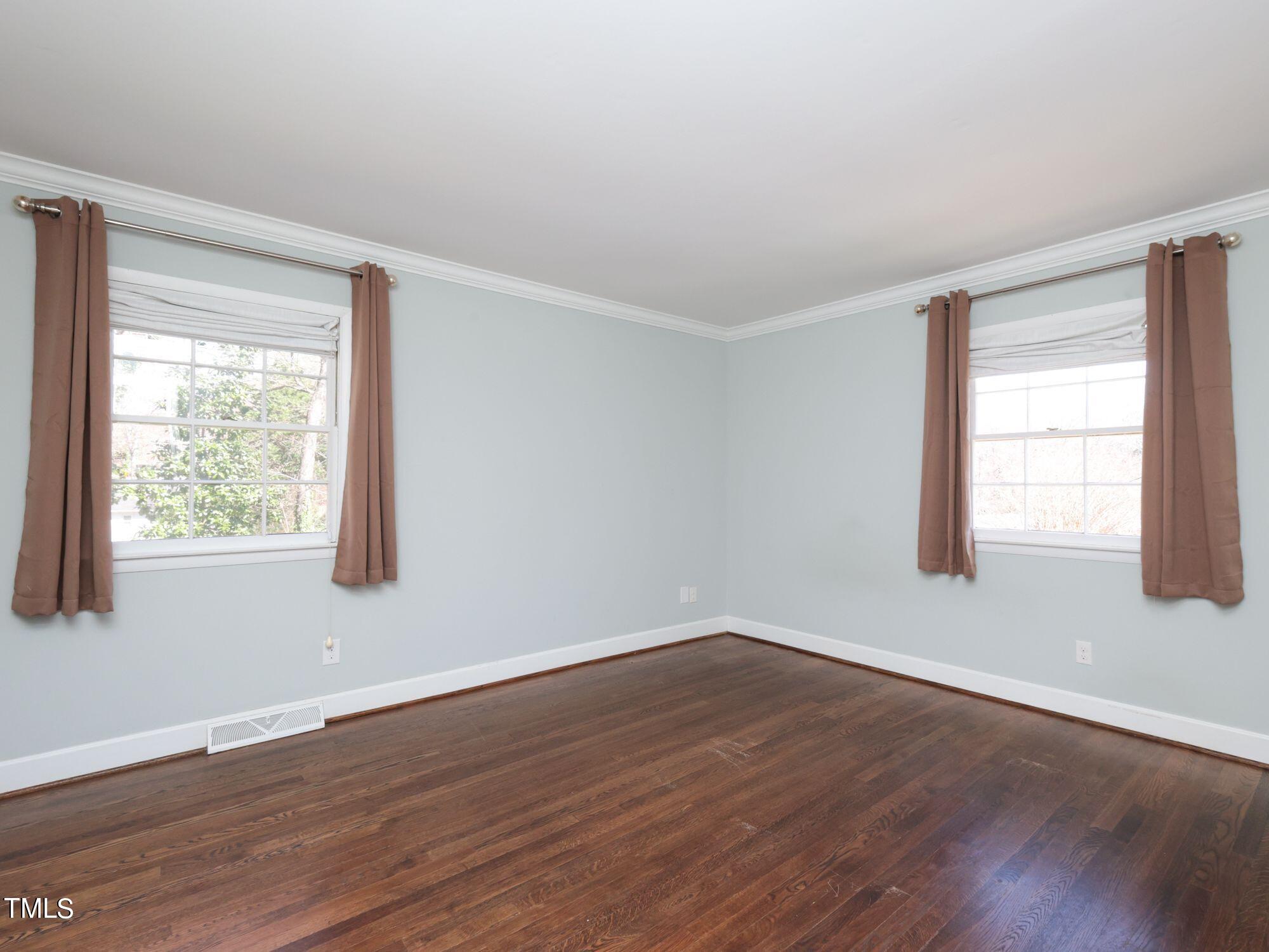 529 Harvard Street Raleigh, NC 27609 - Photo 23 of 48 a view of an empty room with wooden floor and a window