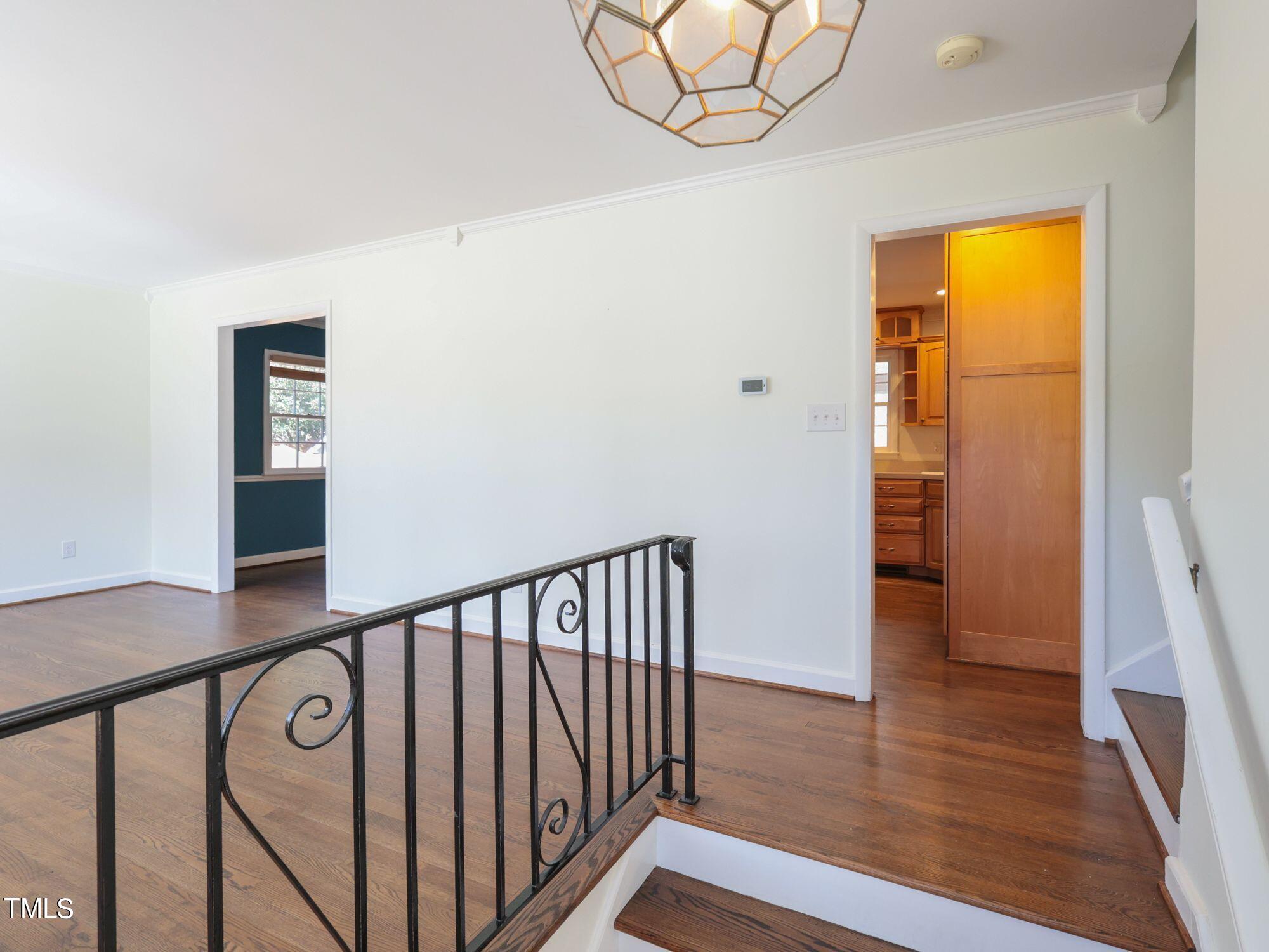 529 Harvard Street Raleigh, NC 27609 - Photo 3 of 48 a view of a hallway with wooden floor and entryway
