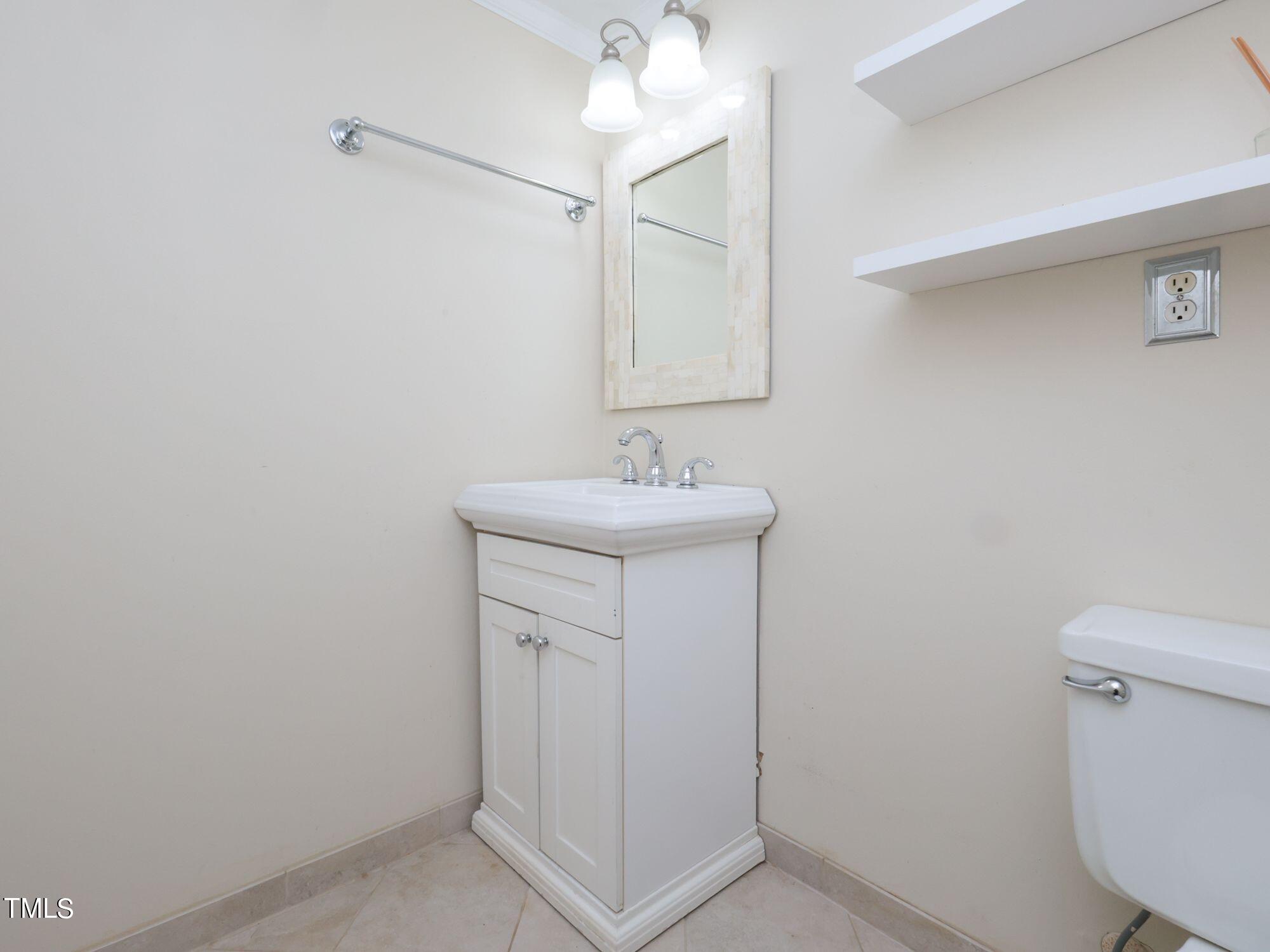 529 Harvard Street Raleigh, NC 27609 - Photo 35 of 48 a bathroom with a sink and a mirror