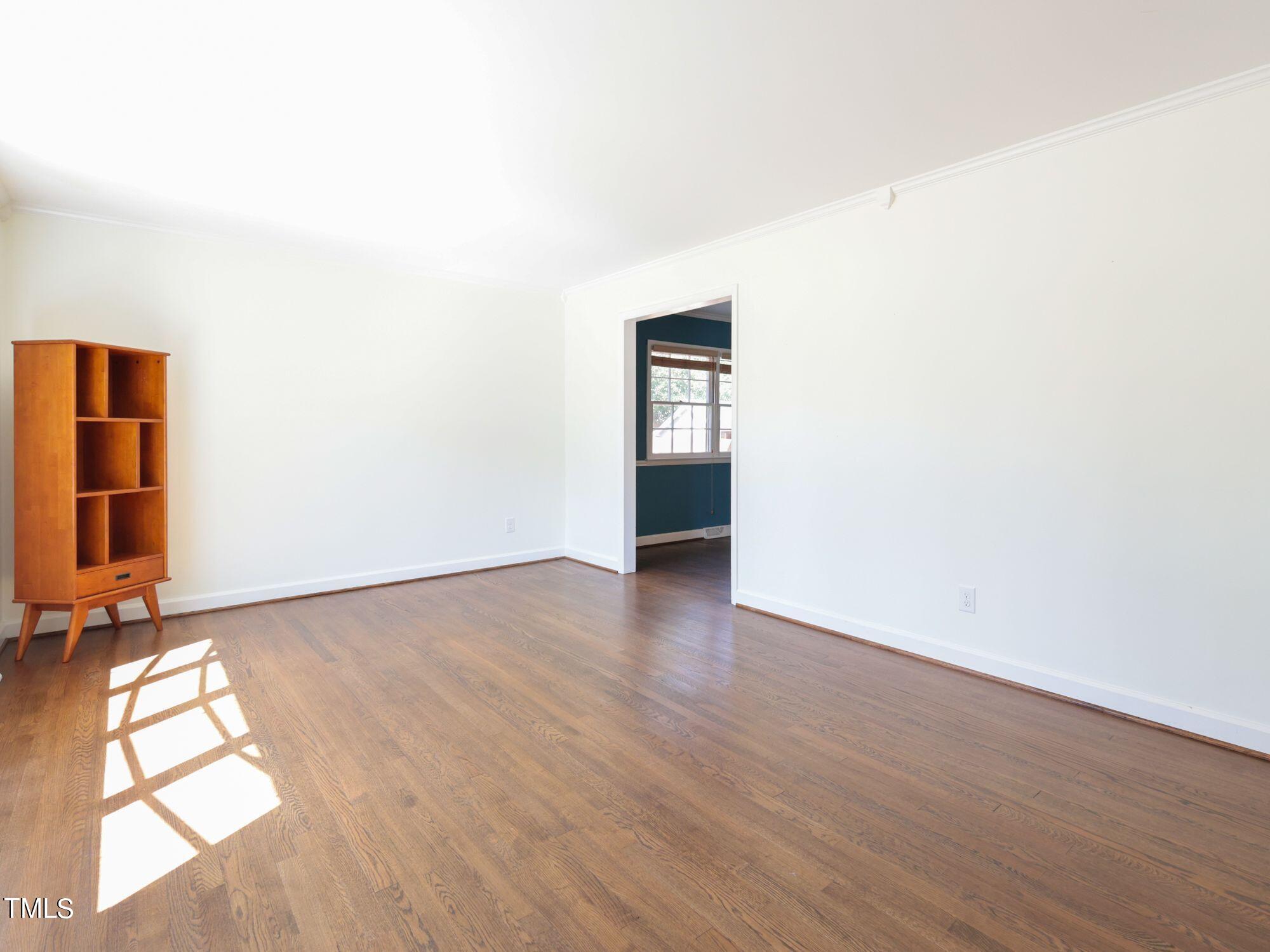 529 Harvard Street Raleigh, NC 27609 - Photo 4 of 48 an empty room with wooden floor and windows