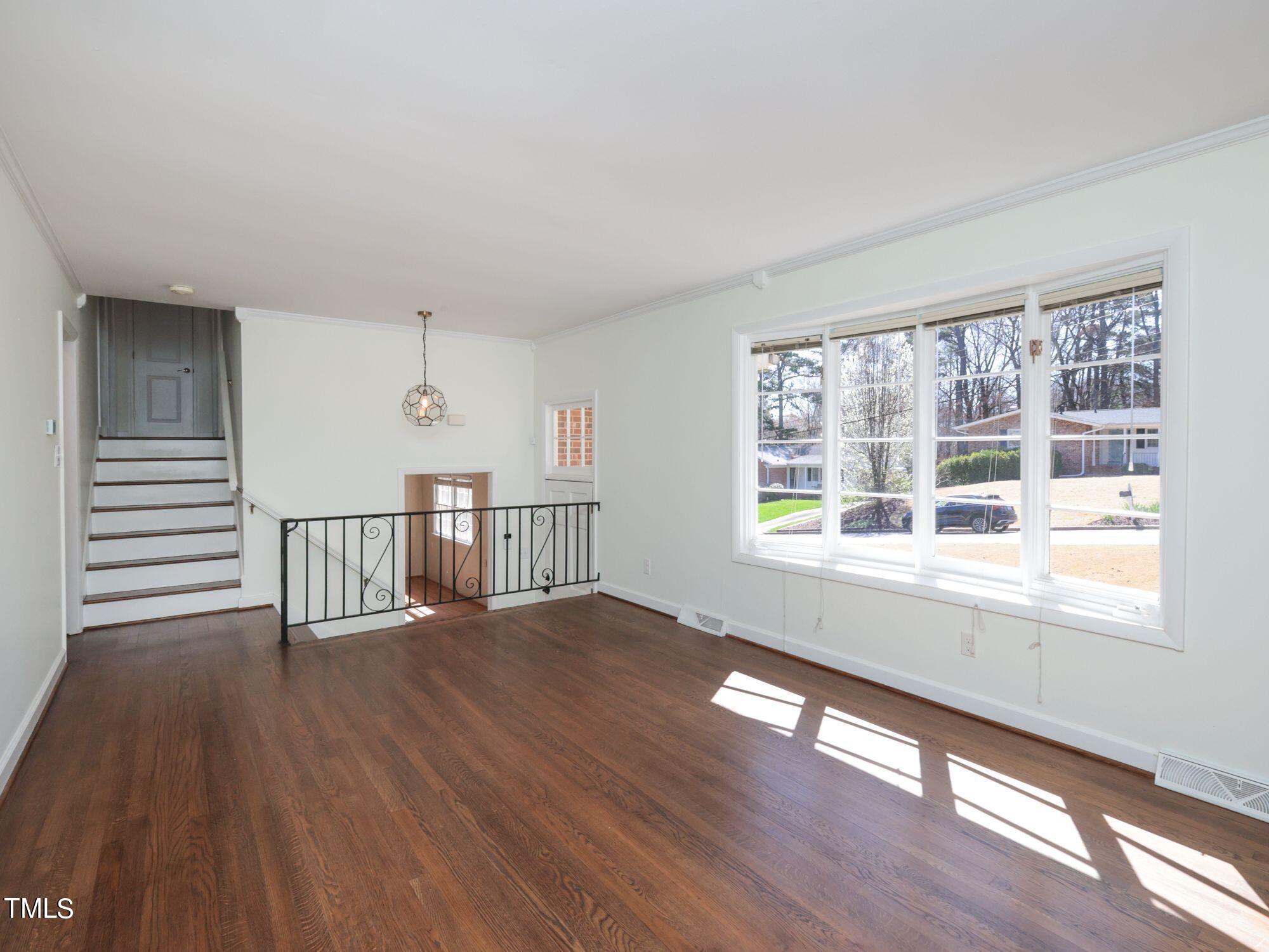 529 Harvard Street Raleigh, NC 27609 - Photo 6 of 48 a view of an empty room with wooden floor and a window