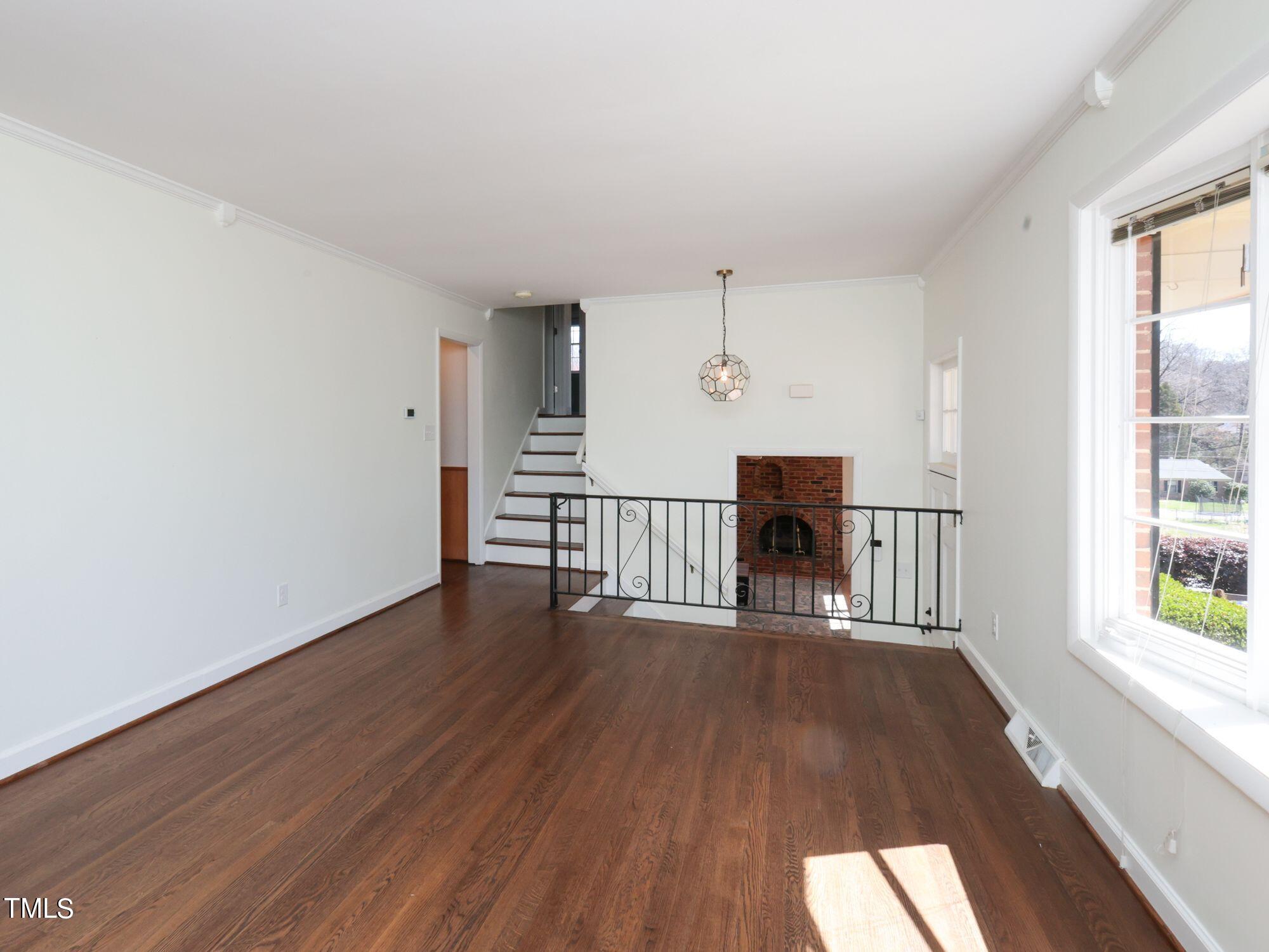 529 Harvard Street Raleigh, NC 27609 - Photo 8 of 48 a view of a livingroom with wooden floor and a fireplace