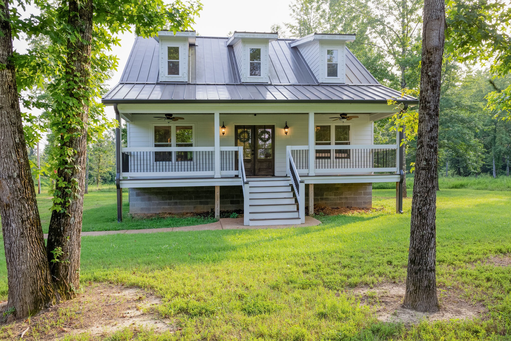 a view of a house with a yard balcony and sitting area