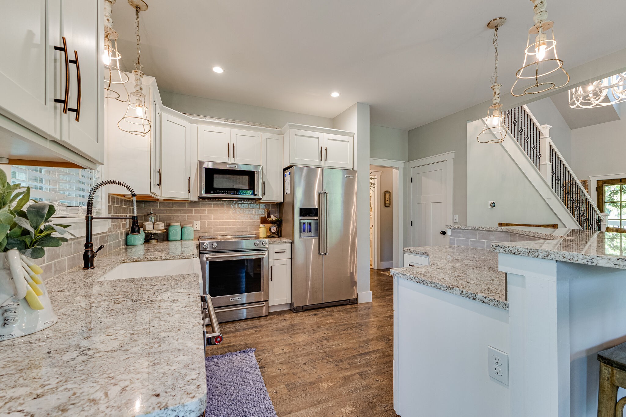 3425 Toms Creek Road Linden, TN 37096 - Photo 12 of 38 a large kitchen with granite countertop a large counter top stainless steel appliances and wooden floor