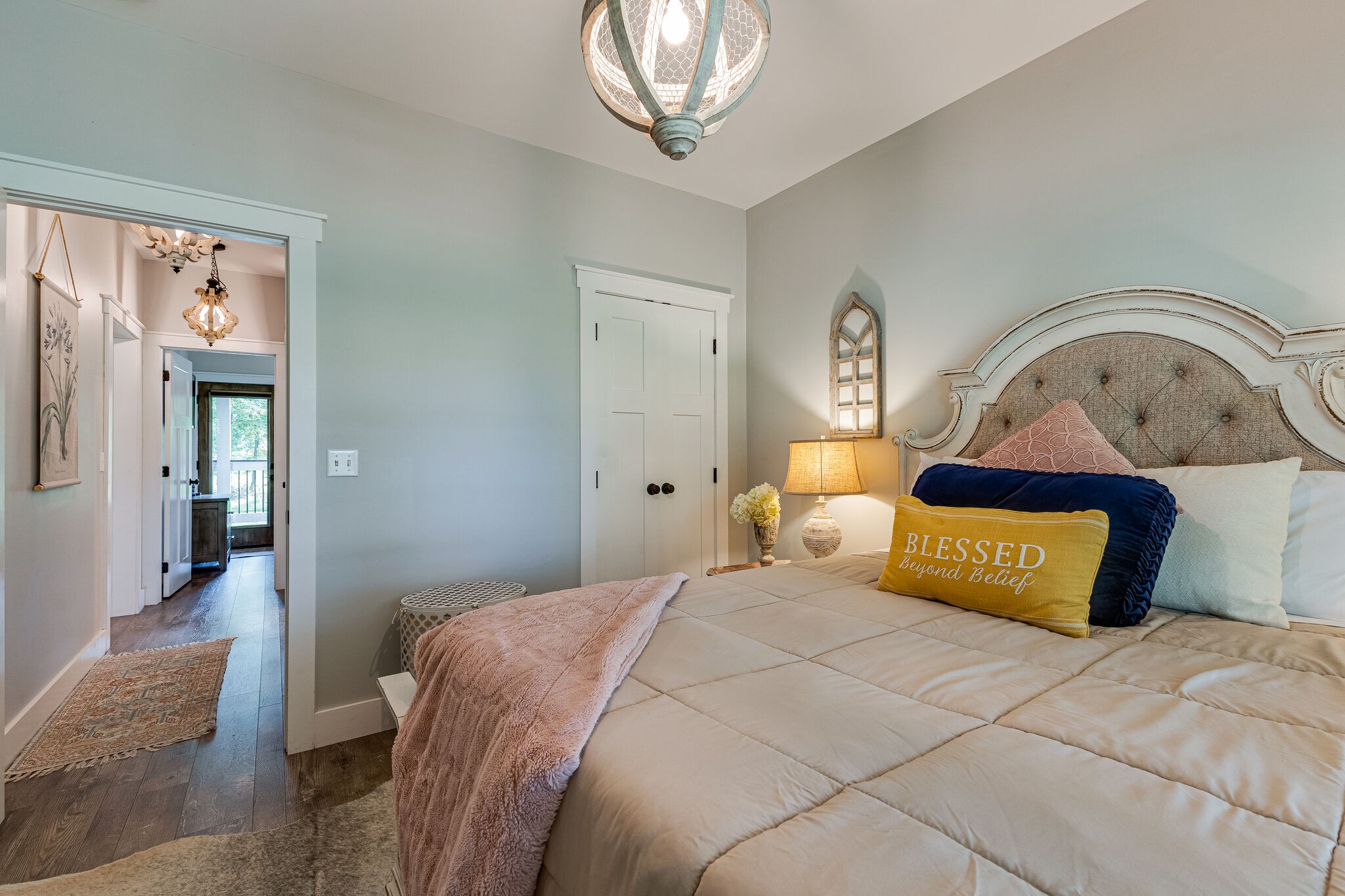 3425 Toms Creek Road Linden, TN 37096 - Photo 16 of 38 a bedroom with a bed and a chandelier