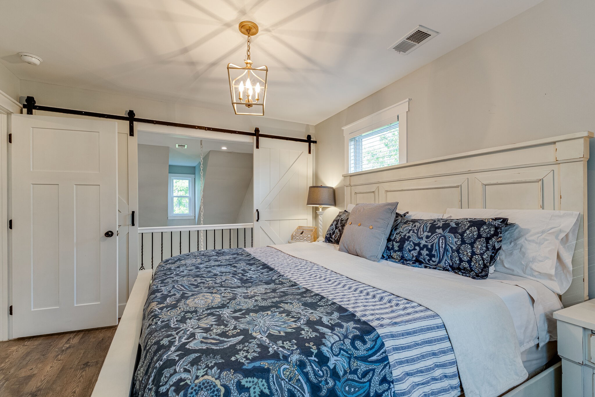 3425 Toms Creek Road Linden, TN 37096 - Photo 21 of 38 a bedroom with a bed and a chandelier