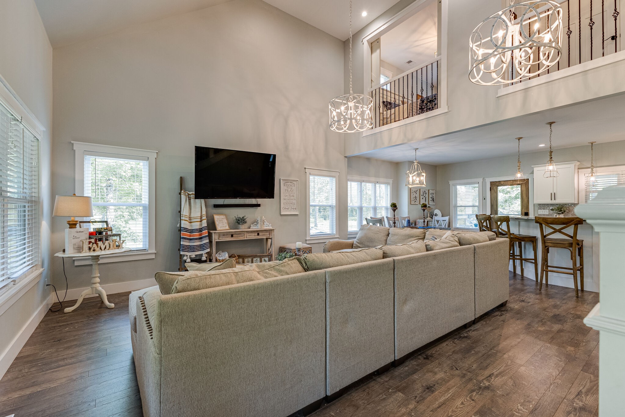 3425 Toms Creek Road Linden, TN 37096 - Photo 7 of 38 a large living room with stainless steel appliances kitchen island granite countertop a large couch and a flat screen tv
