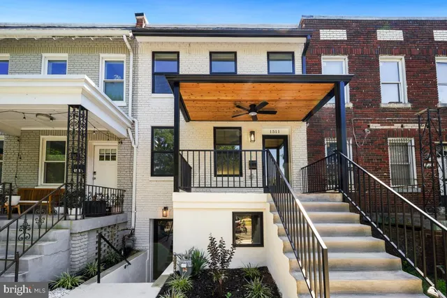 a front view of a house with a yard table and chairs