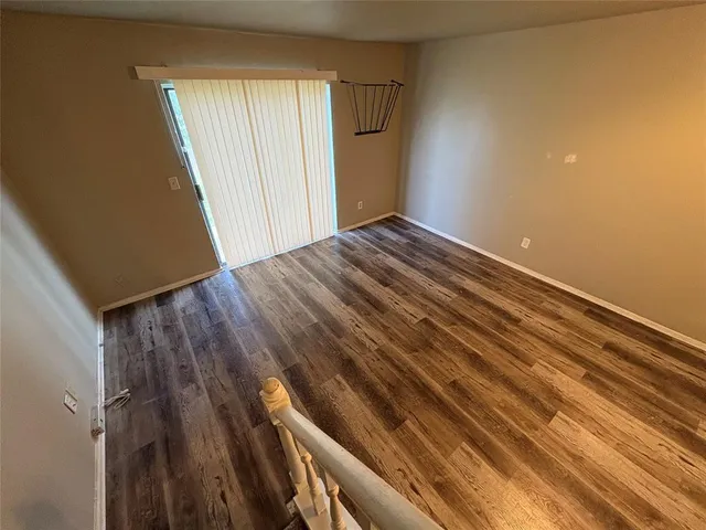 a view of an empty room and wooden floor