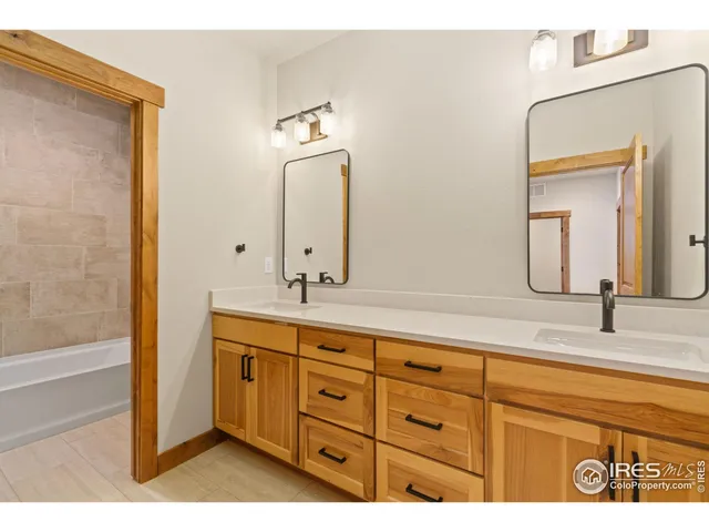 a bathroom with a double vanity sink and a mirror